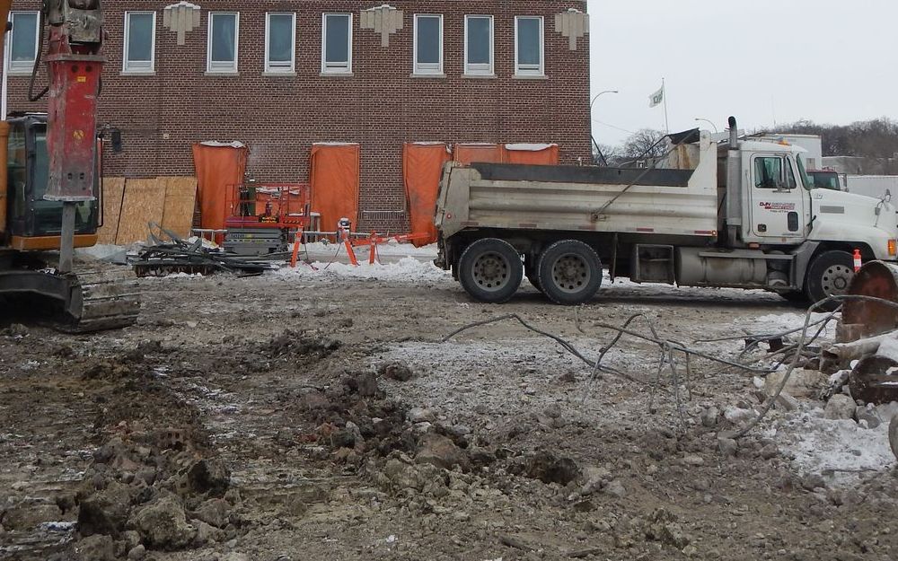 Hydraulic hammer breaking out concrete on a Winnipeg demolition