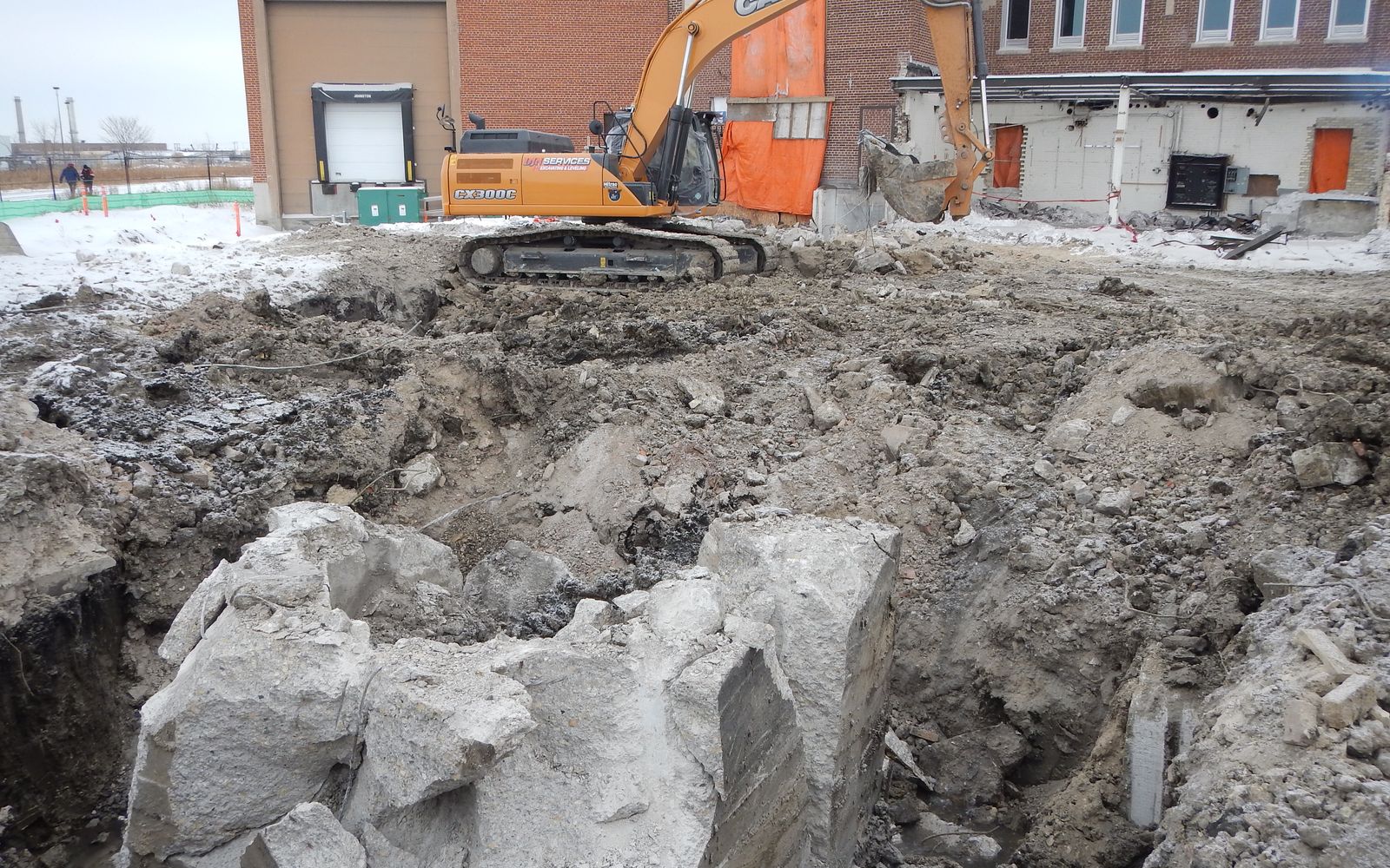 DJN excavator over broken foundation concrete