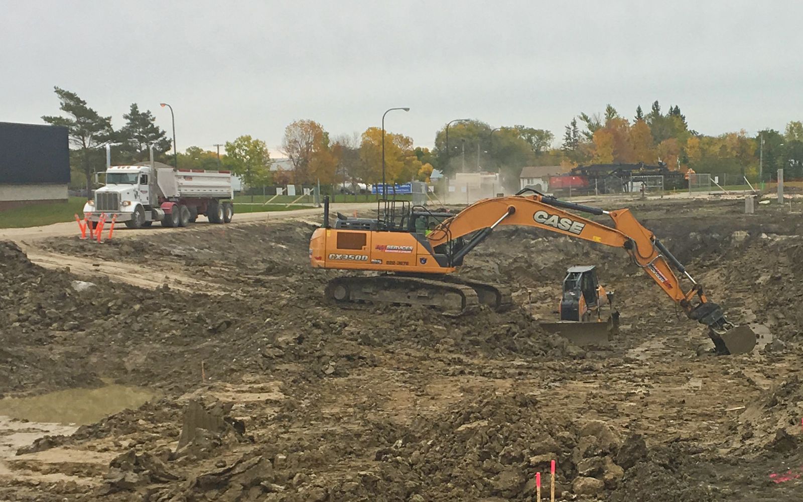 DJN CX350D excavator and end dump on a wet site